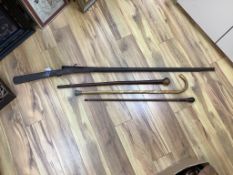 An Indian matchlock rifle and 3 walking sticks