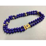 A lapis lazuli necklace with fancy gilt metal clasp, 42cm.