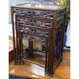 A Chinese nest of four hongmu tables, early 20th century, with a dragon carved freeze, largest
