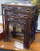 A Chinese nest of four hongmu tables, early 20th century, with a dragon carved freeze, largest