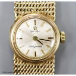 A lady's 9ct gold Omega Ladymatic wrist watch on integral 9ct gold Omega bracelet,verall length 16.
