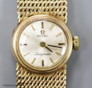 A lady's 9ct gold Omega Ladymatic wrist watch on integral 9ct gold Omega bracelet,verall length 16.