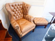 A pair of George III style buttoned tan leather wingback armchairs and two matching