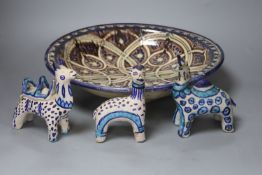 A Moroccan pottery dish, diameter 36cm, and three fritware animal figures