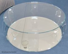 A contemporary glass circular coffee table, with mirrored base, 98 cm wide, 33 cm highProvenance -
