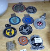 A small collection of car radiator caps and badges and motorcycle club badges