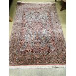 A Kashan style part silk blue ground rug, 185 x 123cm