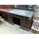 A late Victorian carved oak pedestal desk, length 138cm