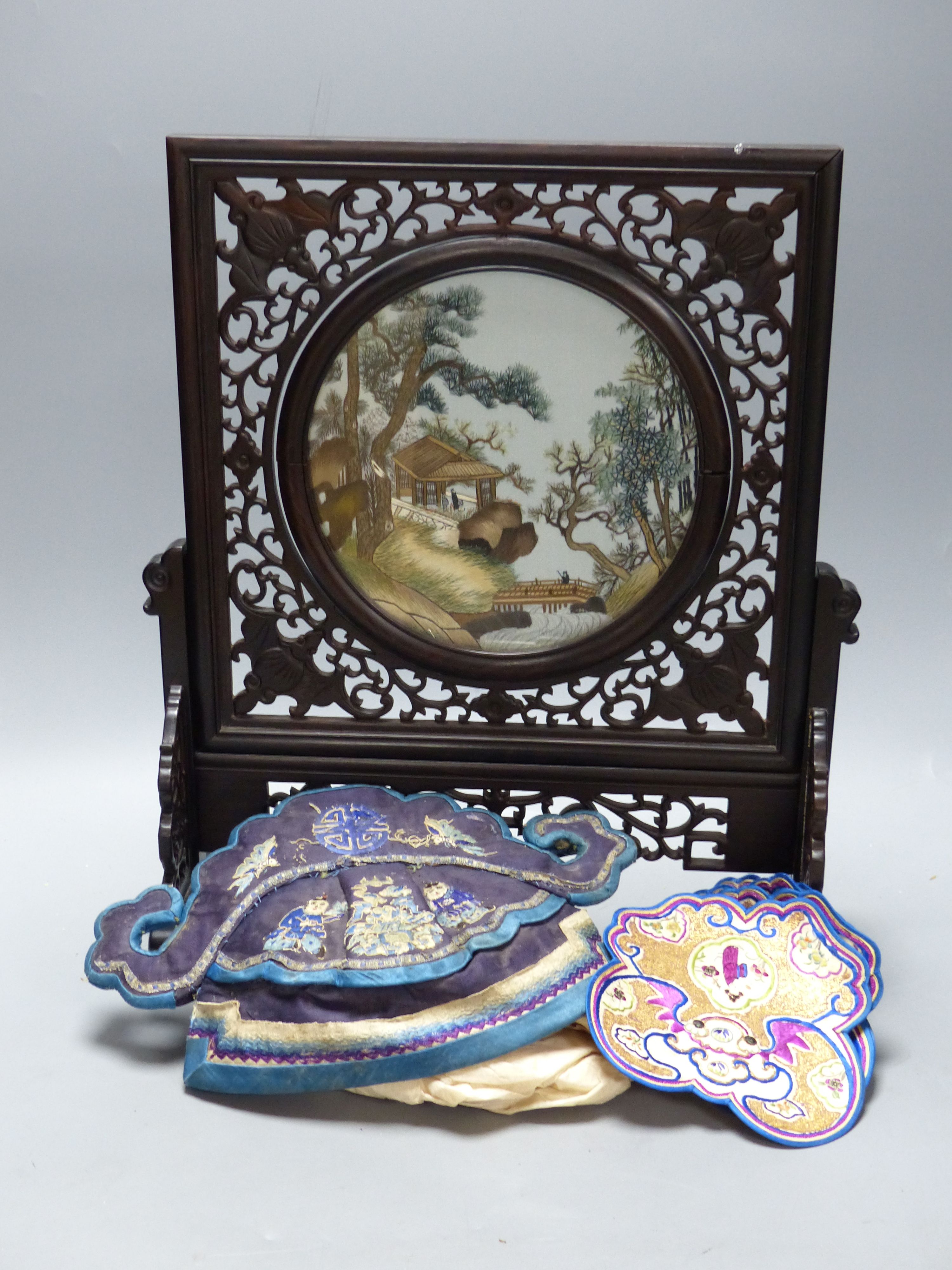 A carved Chinese table stand, 43cm, a mandarin hat and a set of mats