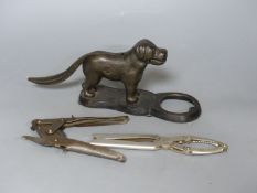 Two metal nutcrackers, and a tin? opener widest 28cm