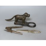 Two metal nutcrackers, and a tin? opener widest 28cm