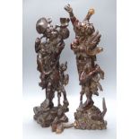 Two early 20th century Chinese hardwood figures of a demon and a fisherman, tallest 61cm
