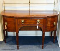 A George III mahogany bow-breakront sideboard, 152cm long, 116.5 cm high to top brass rail, 76 cm