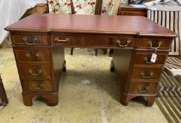 A mahogany breakfront pedestal desk, width 135cm