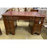 A mahogany breakfront pedestal desk, width 135cm