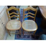 A set of six late Victorian beech kitchen chairs with caned seats