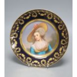 A Vienna style porcelain plate, c.1900, painted with a portrait of a lady wearing a hat, signed