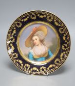 A Vienna style porcelain plate, c.1900, painted with a portrait of a lady wearing a hat, signed