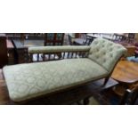 An Edwardian oak chaise longue