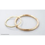 Two yellow metal bangles, the smallest stamped 9ct,gross 15.2 grams.