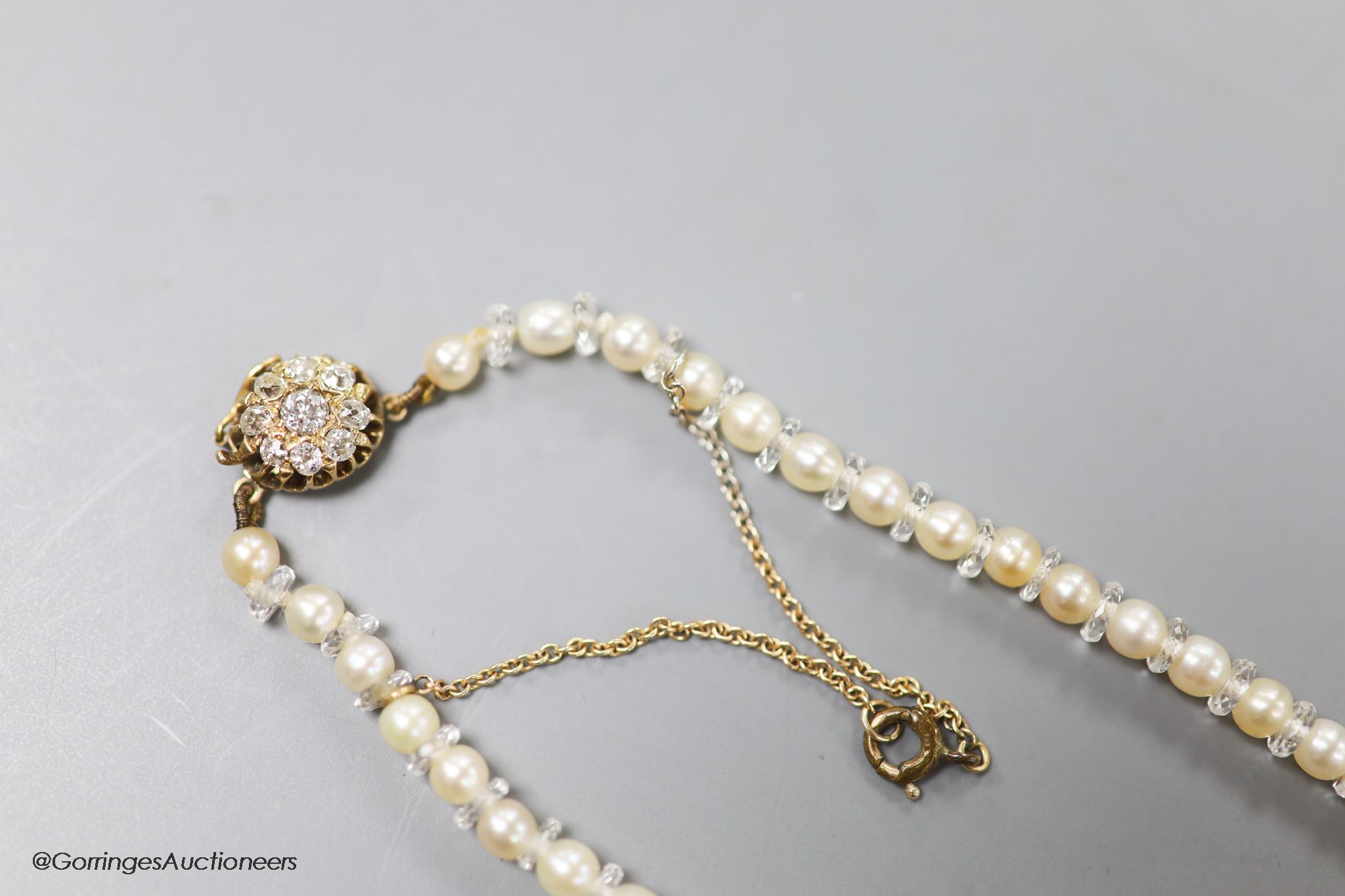 An early 20th century single strand cultured pearl and paste spacer necklace with diamond cluster - Image 2 of 2