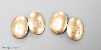 A pair of early 20th century 9ct gold oval cufflinks, engraved with crest and date,14 grams.