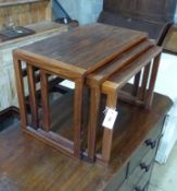 A nest of three 1950’s Danish teak occasional tables, width 62cm