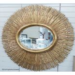 A large contemporary gilt oval 'sunburst' mirror, 145 cm wide, 130 cm highProvenance - a country