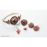 A Victorian gilt metal, facet and cabochon cut garnet set hinged bracelet, a pair of similar