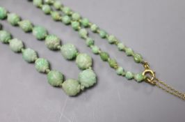 An early 20th century graduated carved jade bead necklace, with 9ct clasp, 47cm, gross weight 30