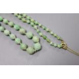 An early 20th century graduated carved jade bead necklace, with 9ct clasp, 47cm, gross weight 30