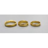 Three assorted 22ct gold wedding bands,14.5 grams.