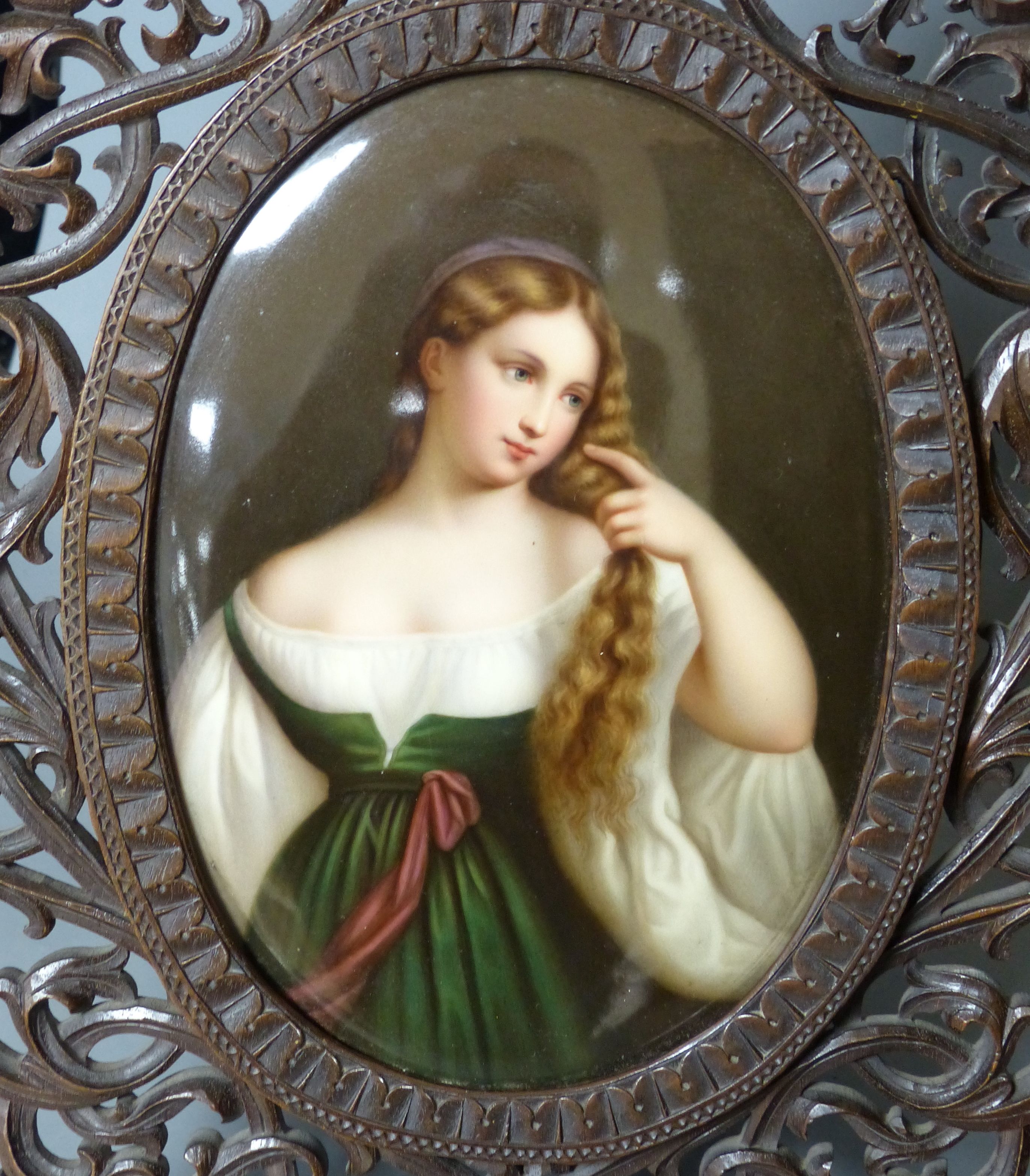 A large 19th century painted Paris porcelain plaque of a girl in a Black Forest carved frame, - Image 2 of 3