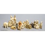 Fourteen Japanese ivory netsuke, a Chinese ivory group and elephant figure, all early 20th century