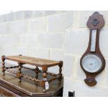 An oak footstool, width 76cm, depth 30cm, height 27cm and an aneroid barometer, length 58cm, width