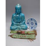 A Chinese ceramic buddha, height 40cm, a blue and white dish, and two leather wall hangings, Qing