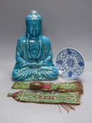 A Chinese ceramic buddha, height 40cm, a blue and white dish, and two leather wall hangings, Qing