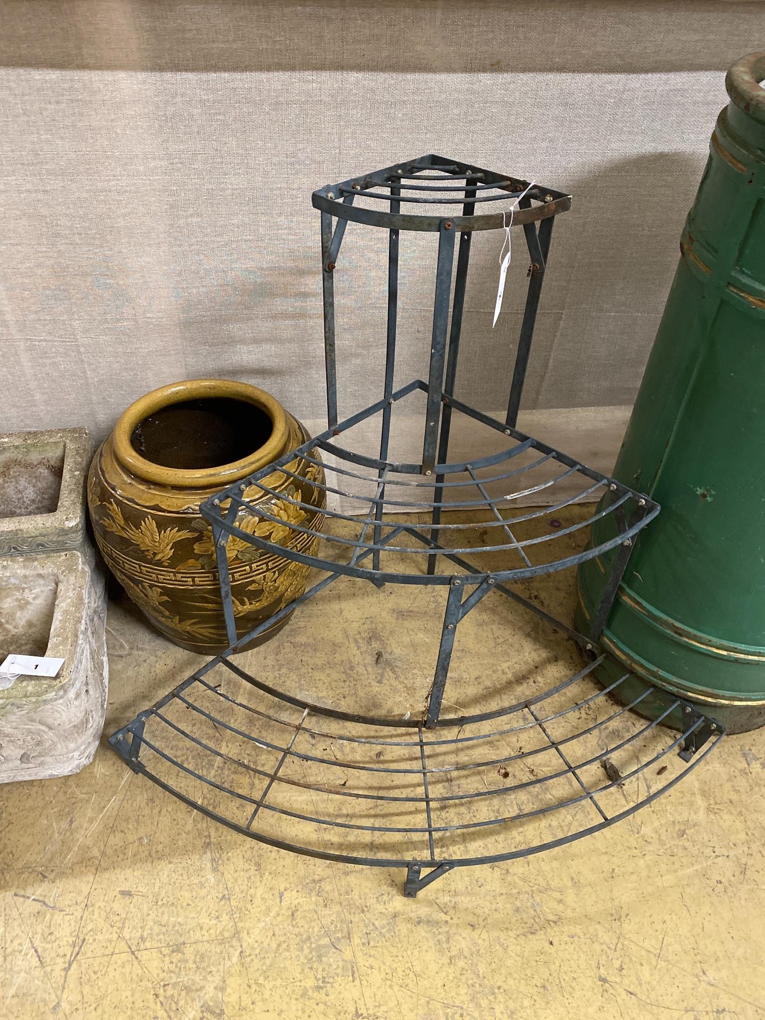 A wrought iron three tier plant stand, height 75cm and a tin glazed vase,