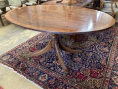 A Regency style oval banded mahogany dining table, length 150cm, depth 103cm, height 76cm