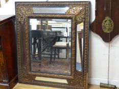 A 19th century Dutch ebonised and gilt metal mounted mirror, width 95cm, height 110cm