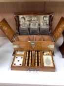 A Victorian oak tantalus and games compendium, height 33cm depth 29cm width 38cm