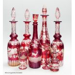 A collection of six Bohemian ruby flashed wheel engraved glass decanters, tallest 40cm, a similar