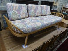 An Ercol light elm and beech settee 'surfboard' settee, length 206cm, depth 75cm, height 72cm