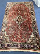 A red ground Persian rug, 210 x 135cm together with a smaller Caucasian style runner