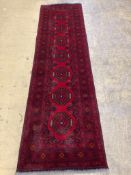 A Bokhara red ground runner, 290 x 82cm