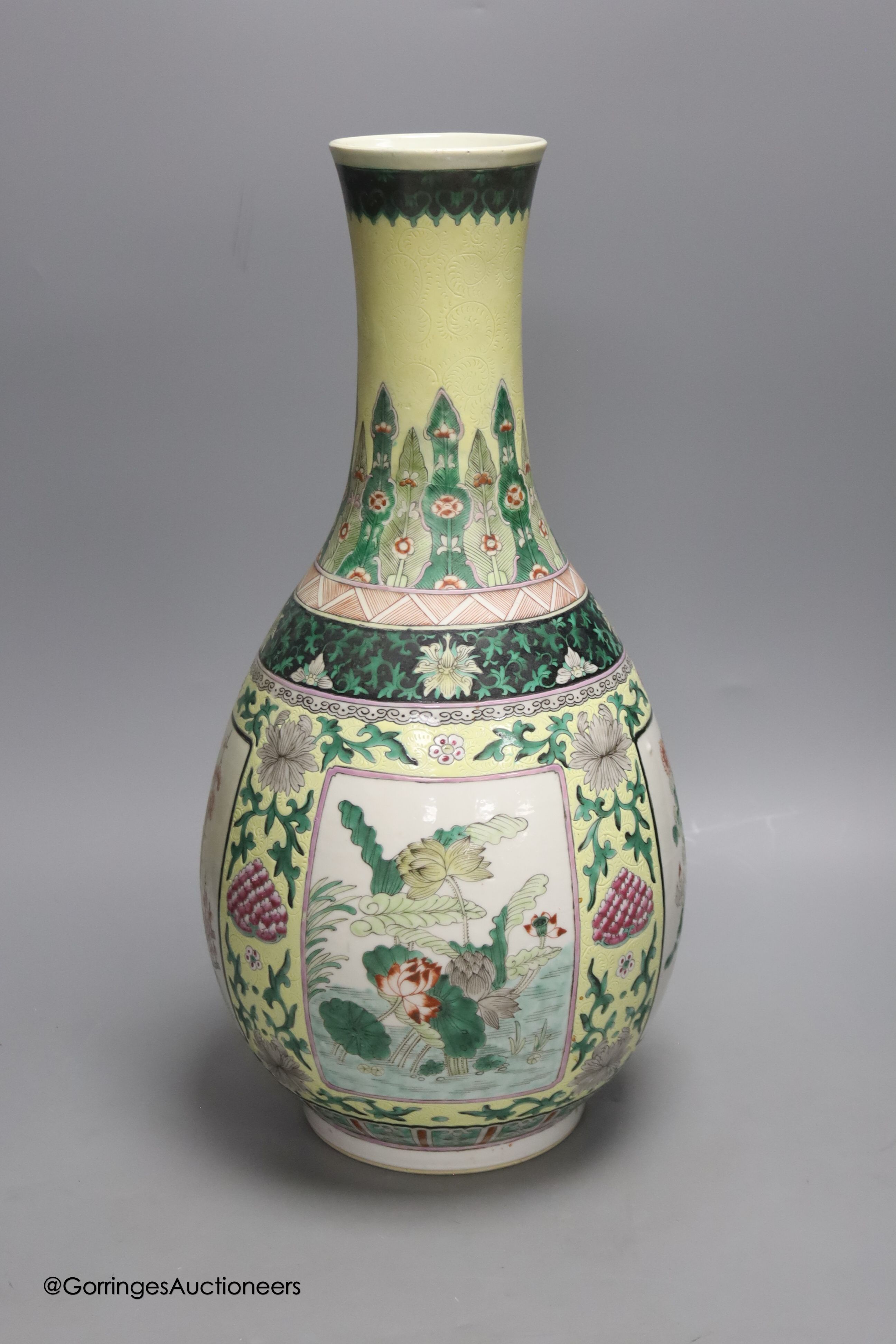 A large 19th century Chinese famille verte yellow ground bottle vase, height 47cm, restorations