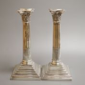 A pair of Edwardian silver Corinthian column candlesticks by Williams (Birmingham) Ltd, Birmingham,