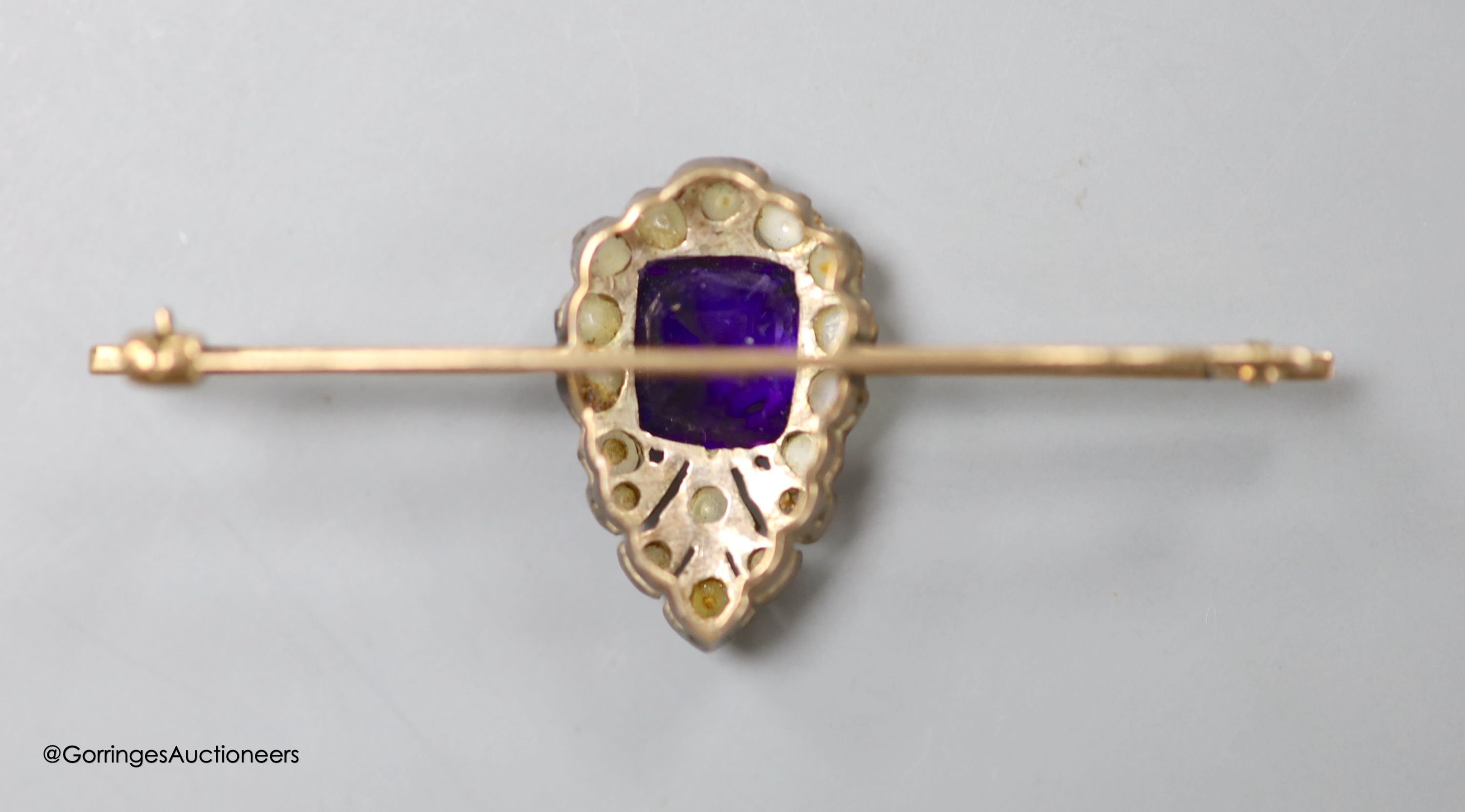 An Edwardian yellow metal, amethyst and split pearl set bar brooch, 54mm, gross weight 4.5 grams. - Image 2 of 2