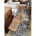 A pair of brass mounted teak garden steamer chairs