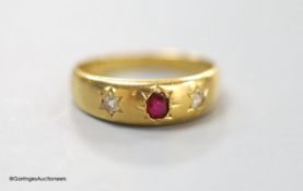 A Victorian 18ct gold and gypsy set, ruby and diamond three stone ring, size M, gross 3.5 grams.